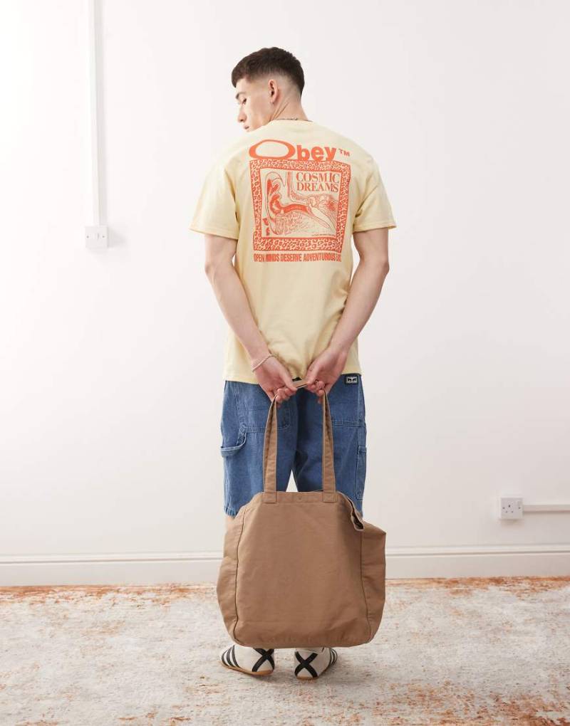 Obey - T-Shirt in Blassgelb mit „Cosmic Dreams"-Logoprint und Rückenprint von Obey