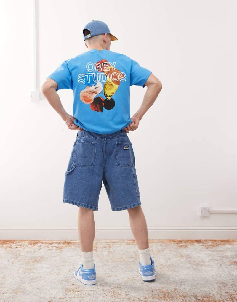 Obey - T-Shirt in dunklem Blaugrün mit „Obey Studios"-Logo und Rückenprint von Obey