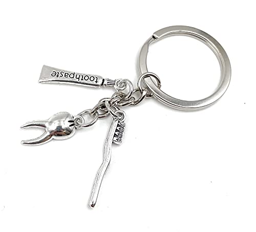 Onwomania Zahn Zahnbürste Zahnfee Schlüsselanhänger Metall Glücksbringer in Alu Geschenkbox, ideal zum Verschenken von Onwomania