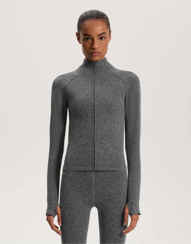 OYSHO - Leichte, warme und nahtlose Funktionsjacke in meliertem Dunkelgrau OYSHO - Leichte, warme und nahtlose Funktionsjacke in meliertem Dunkelgrau von Oysho