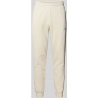 PUMA PERFORMANCE Sweatpants mit Label-Stitching und elastischem Bund in Offwhite, Größe M von PUMA PERFORMANCE