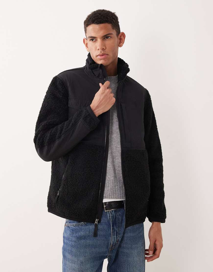 Polo Ralph Lauren - Hybrid-Funktionsjacke in Schwarz mit Teddyfell-Futter, Reißverschluss und Markenlogo von Polo Ralph Lauren