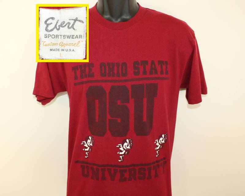 Die Ohio State Buckeyes Vintage T-Shirt M Bordeaux 80Er Jahre Ebert-College-Fußball-Universität Ncaa Brutus Die Ohio State Buckeyes Vintage T-Shirt M Bordeaux 80Er Jahre Ebert-College-Fußball-Universität Ncaa Brutus von PreserveVintage
