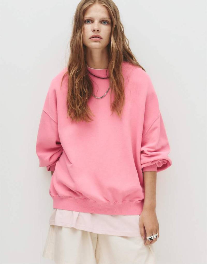 Pull & Bear - Sweatshirt in Mittelrosa mit „Pacific Republic"-Label von Pull & Bear