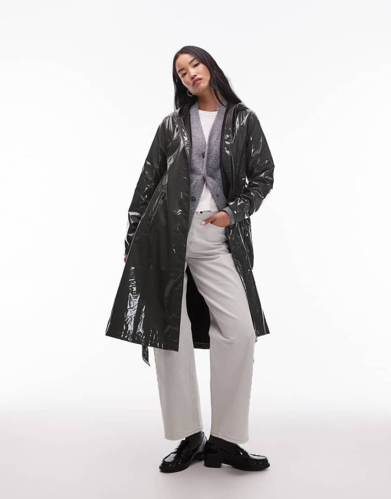 Rains - 12040 - Wasserdichte, längere Jacke in glänzendem Grün mit Bindegürtel und A-Linien-Schnitt von Rains