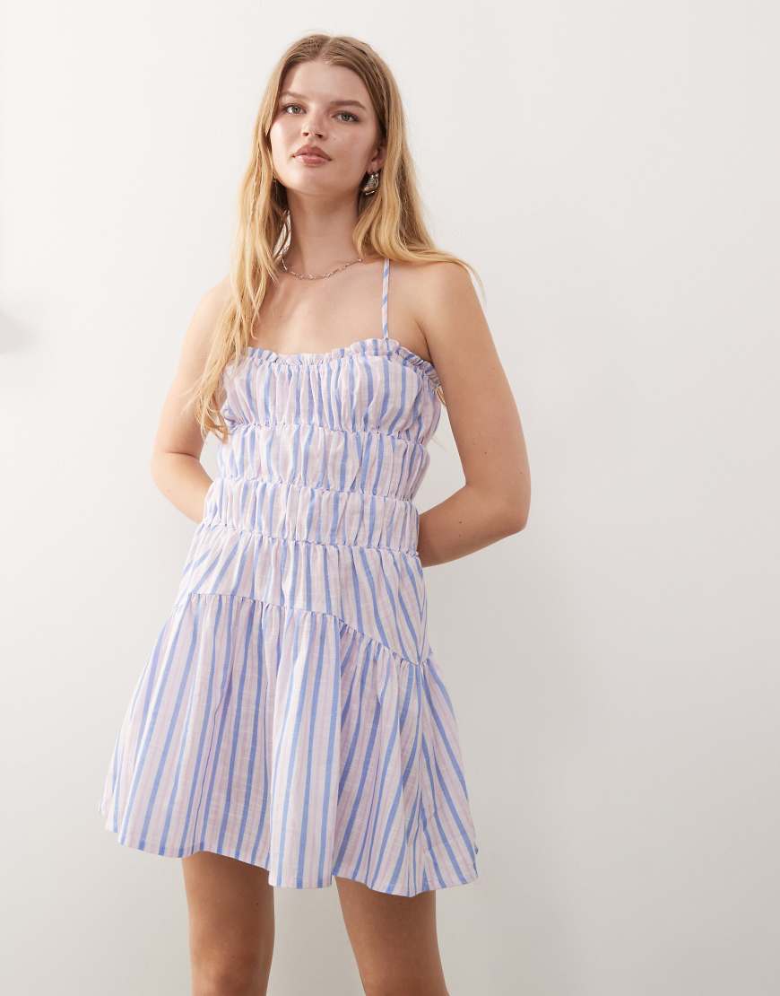 Reclaimed Vintage - Mini-Sommerkleid mit Raffung, hinten überkreuzten Trägern und lila Streifen-Bunt Reclaimed Vintage - Mini-Sommerkleid mit Raffung, hinten überkreuzten Trägern und lila Streifen-Bunt von Reclaimed Vintage
