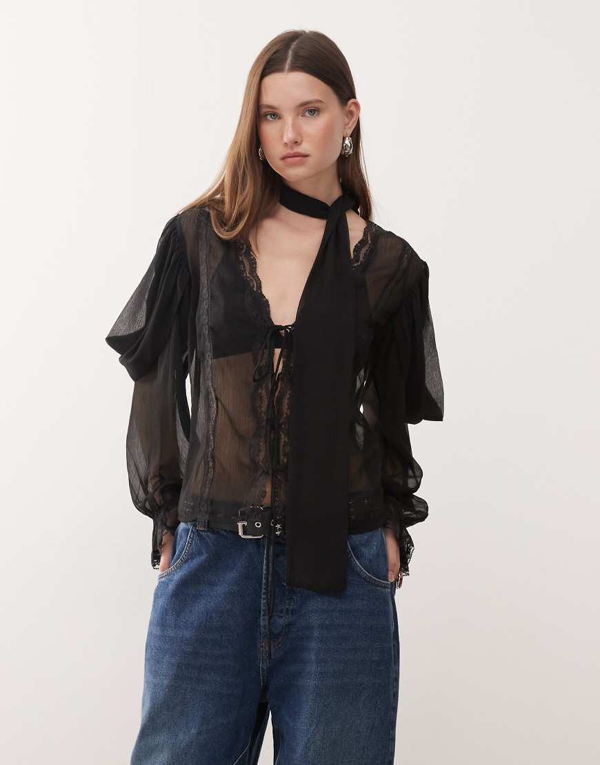 Reclaimed Vintage - Langärmlige, transparente Bluse in Schwarz mit Spitzenborte und schmalem Schal von Reclaimed Vintage