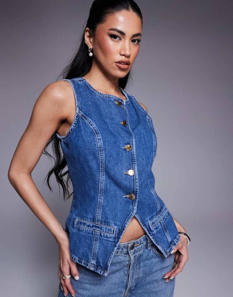 River Island - Jeansweste in mittelblauer Waschung River Island - Jeansweste in mittelblauer Waschung von River Island