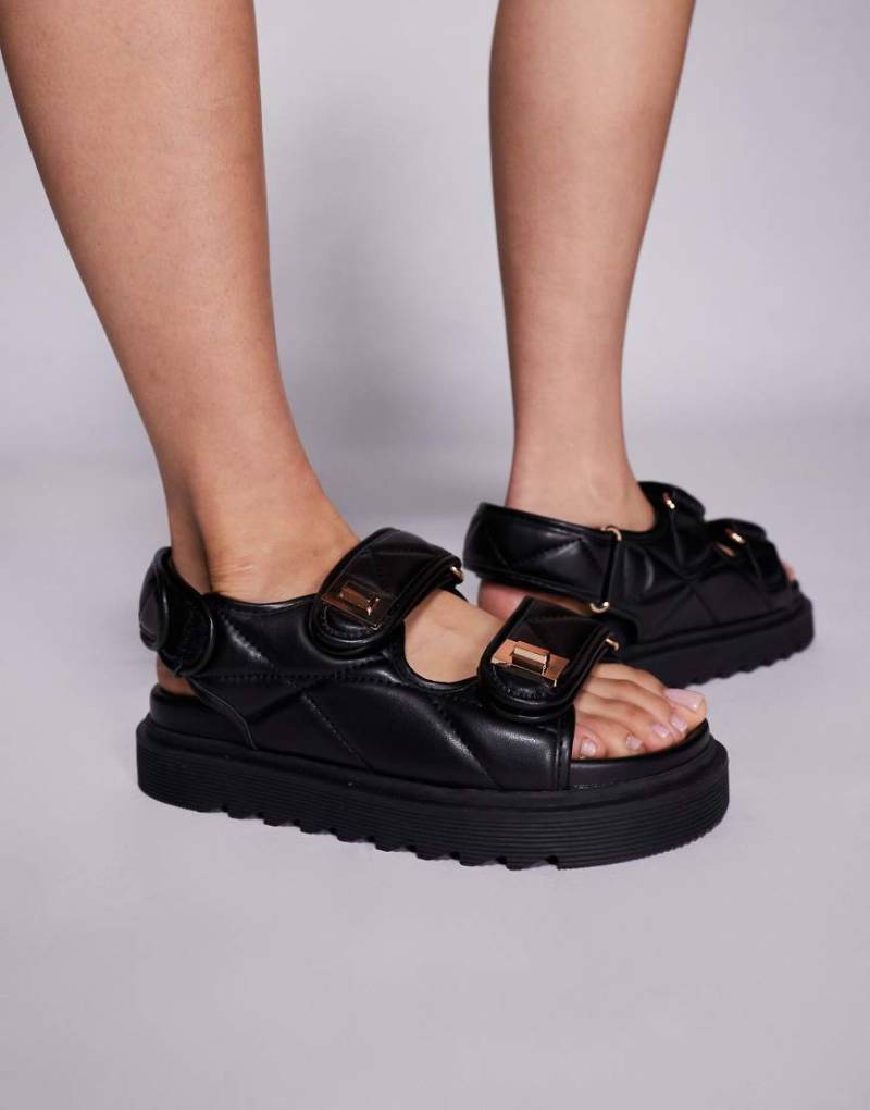 Simmi London - Eboni - Flache Sandalen aus schwarzem Kunstleder mit dicker Sohle von SIMMI Shoes