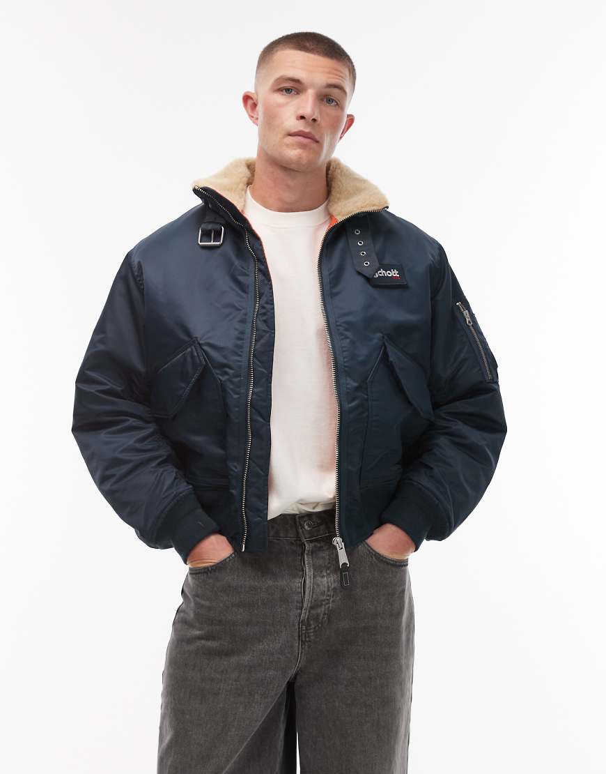 Schott - Wattierte Cropped Jacke in Marineblau mit Logo-Aufnäher, Schnallendetail, Reißverschlusstaschen und Kunstpelzkragen von Schott