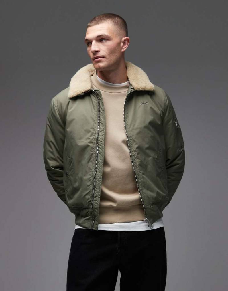 Schott - Wattierte Cropped Jacke in Salbeigrün/Beige mit Logo-Aufnäher, Reißverschlusstaschen und Kunstpelzkragen von Schott