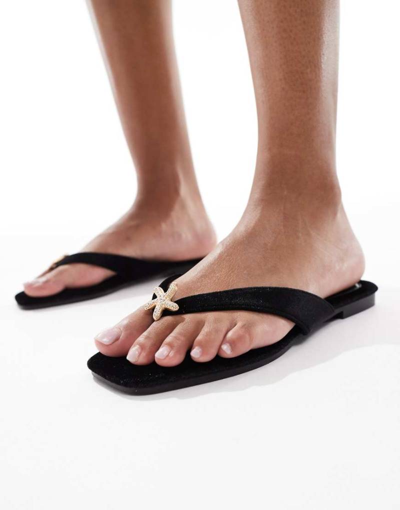 South Beach - Zehenstegsandalen aus schwarzem Samt mit Seesterndetail South Beach - Zehenstegsandalen aus schwarzem Samt mit Seesterndetail von South Beach