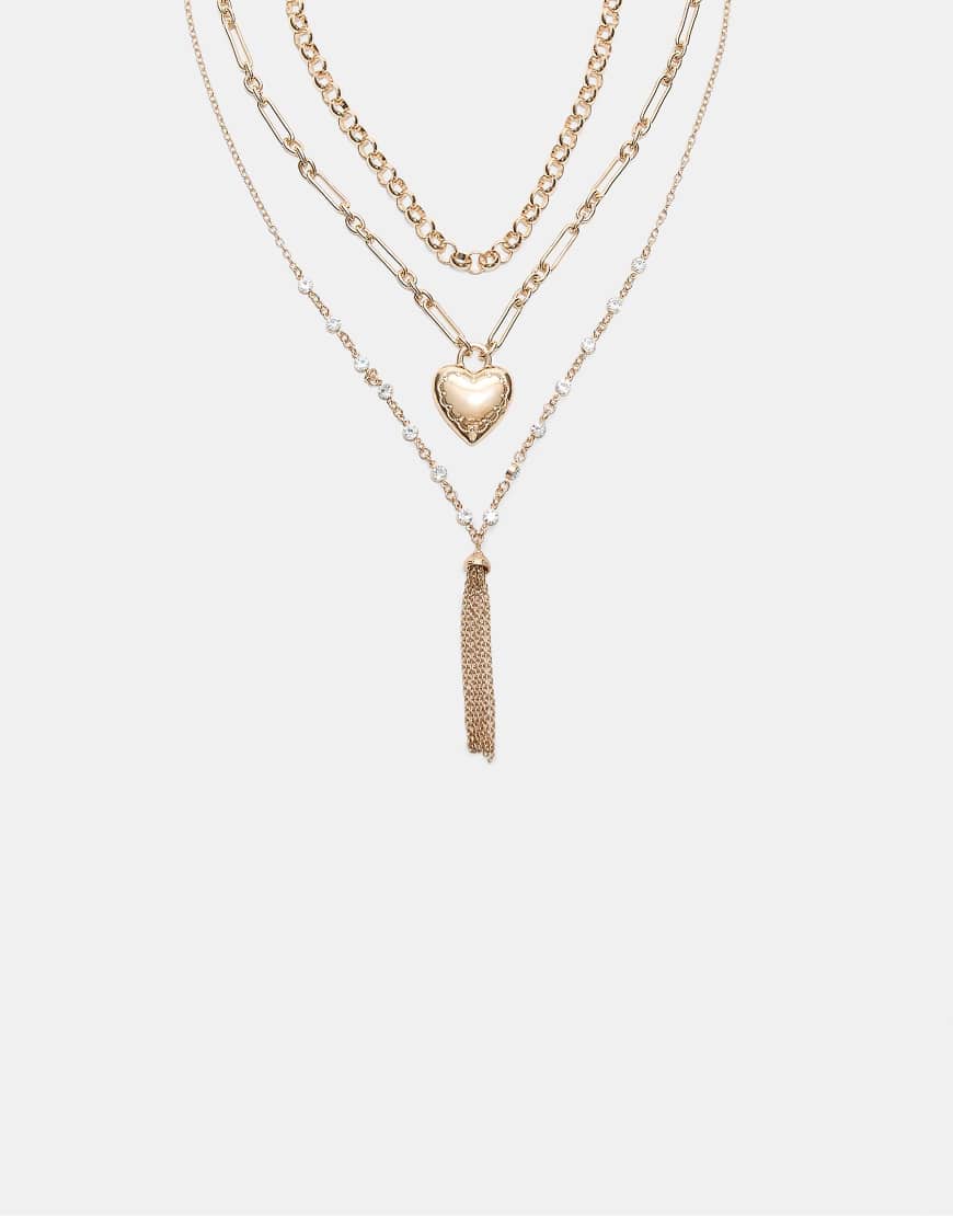 Stradivarius - 3er-Set Halsketten in Gold-Optik mit Herzdetail und Quaste-Gelb Stradivarius - 3er-Set Halsketten in Gold-Optik mit Herzdetail und Quaste-Gelb von Stradivarius