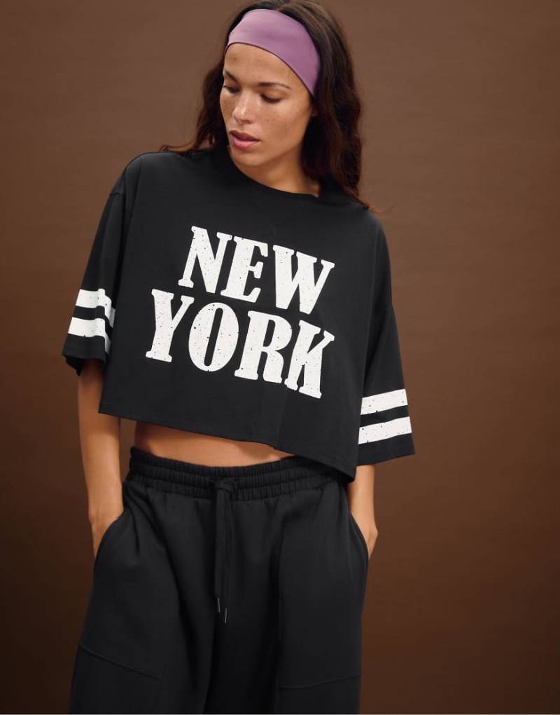 Stradivarius - Cropped T-Shirt in Schwarz mit „New York"-Print von Stradivarius