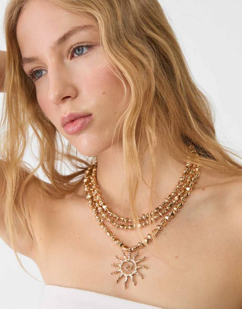 Stradivarius - Lange Halskette in Goldoptik mit Sonnenanhänger-Gelb von Stradivarius