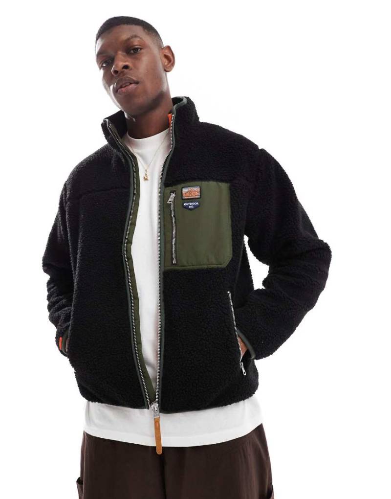 Superdry - Fleece-Jacke in Schwarz mit Reißverschluss in Vintage-Retrodesign von Superdry