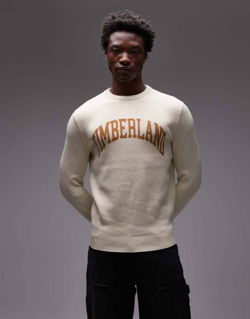 Timberland - Rundhals-Strickpullover in Wollweiß mit College-Logo auf der Brust von Timberland