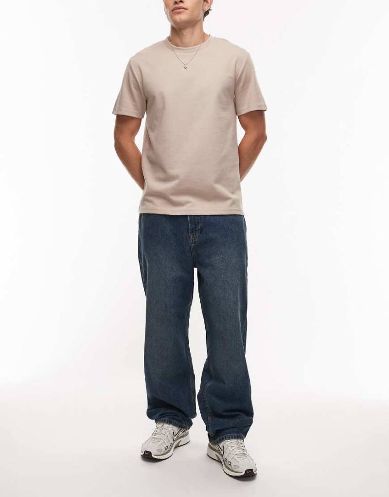 Timberland - Weite Jeans in mittelblauer Waschung mit Tasche mit Logo von Timberland