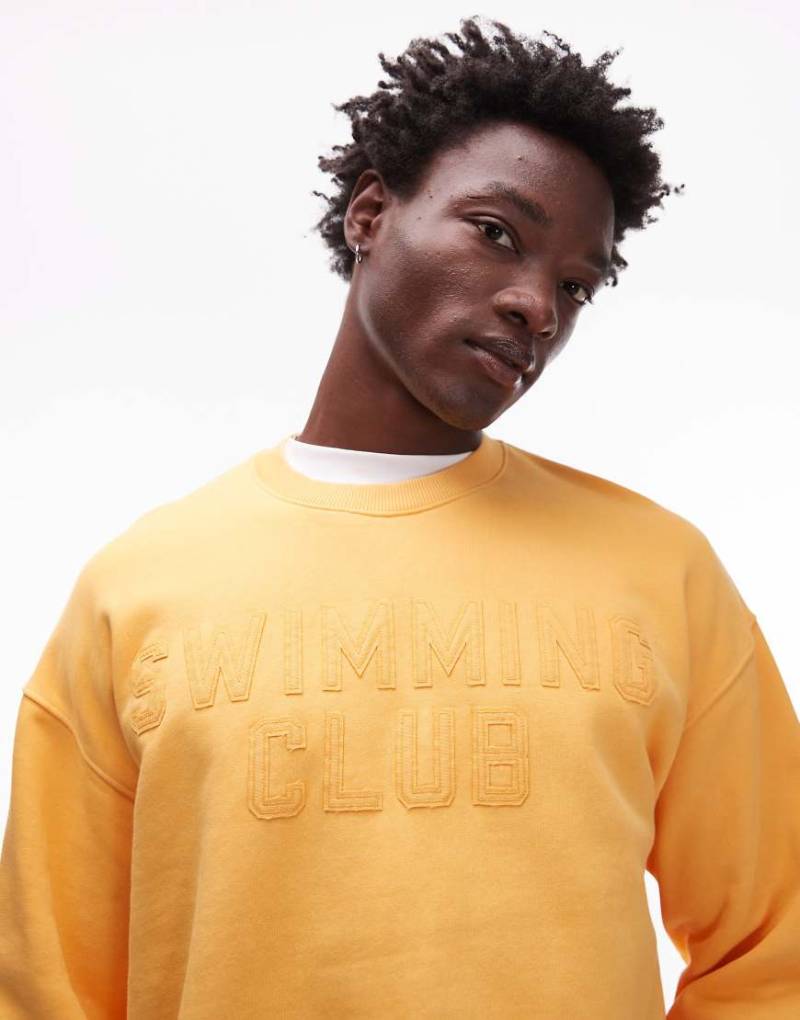 Topman - Oversize-Sweatshirt in verwaschenem Orange mit „Swimming Club"-Stickerei von Topman