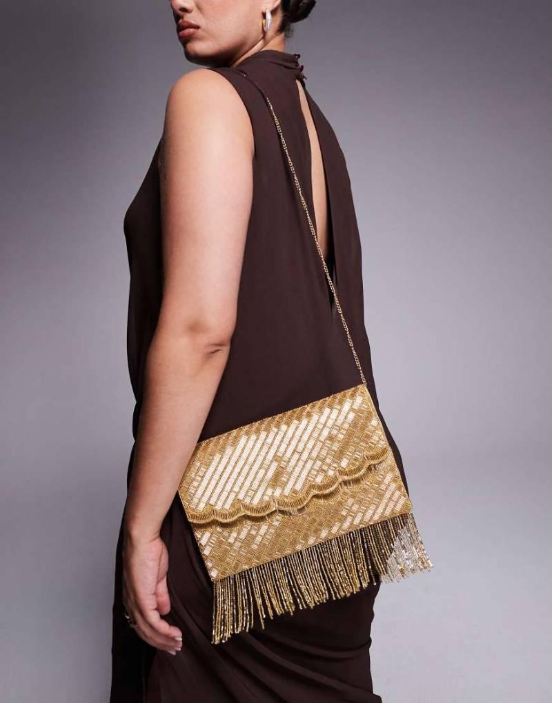 True Decadence - Mit Quasten verzierte Kuvert-Clutch in Goldoptik-Goldfarben True Decadence - Mit Quasten verzierte Kuvert-Clutch in Goldoptik-Goldfarben von True Decadence