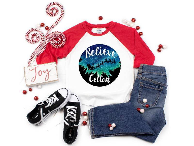 Glauben Sie Santa Weihnachten Shirt Unisex Mädchen Oder Junge Personalisierte Raglan Name Und Rentierschlitten Sternennacht von TwoDreamsShop
