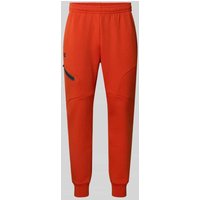 Under Armour Slim Fit Sweatpants Logo-Print Modell 'Unstoppable' in Hellrot, Größe L von Under Armour