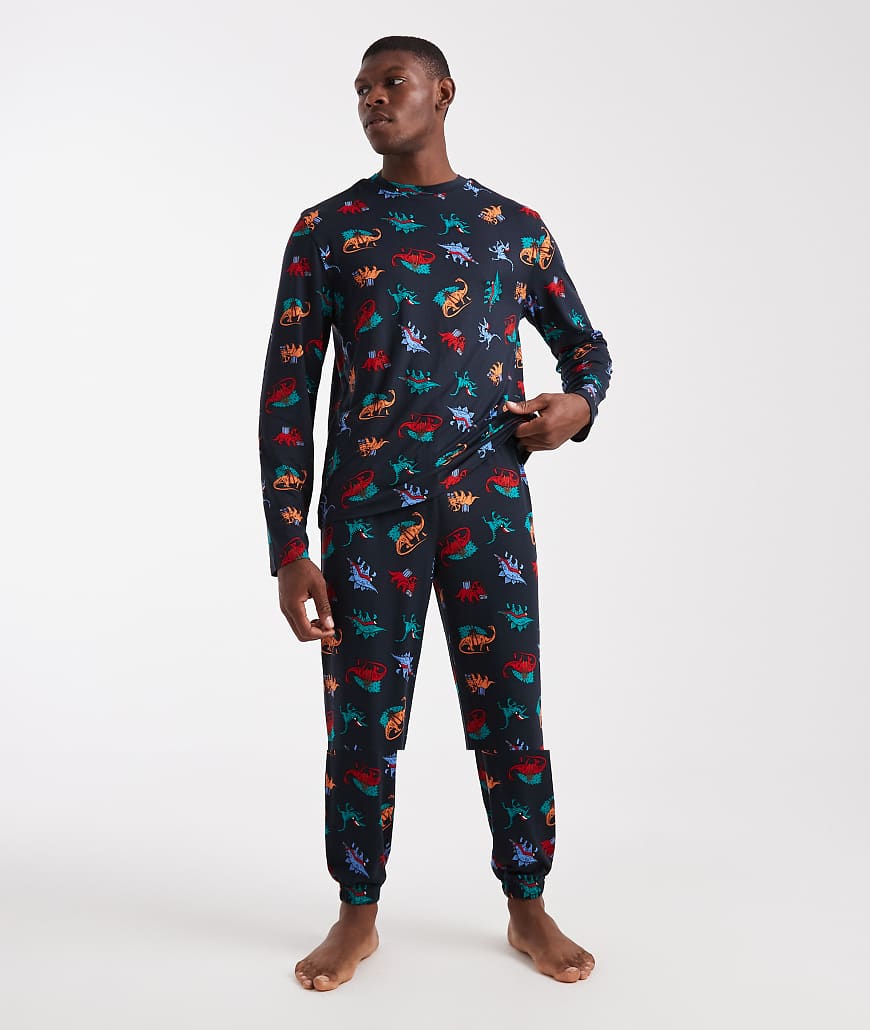 Urban Threads - Weihnachten - Langärmliges Oberteil mit Rundhalsausschnitt und Pyjama-Hose in Marineblau mit Dinosaurier-Printmuster von Urban Threads