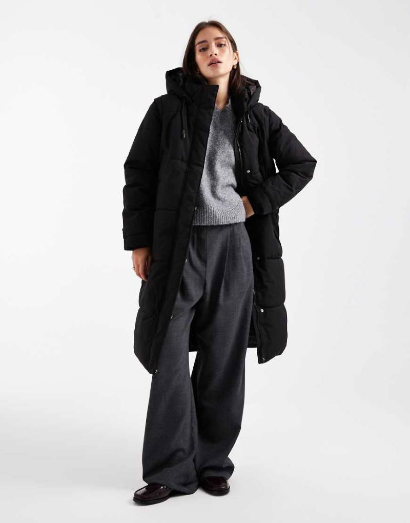 Vero Moda - 2-in.1 - Longline-Steppmantel in Schwarz mit abnehmbaren Ärmeln Vero Moda - 2-in.1 - Longline-Steppmantel in Schwarz mit abnehmbaren Ärmeln von Vero Moda