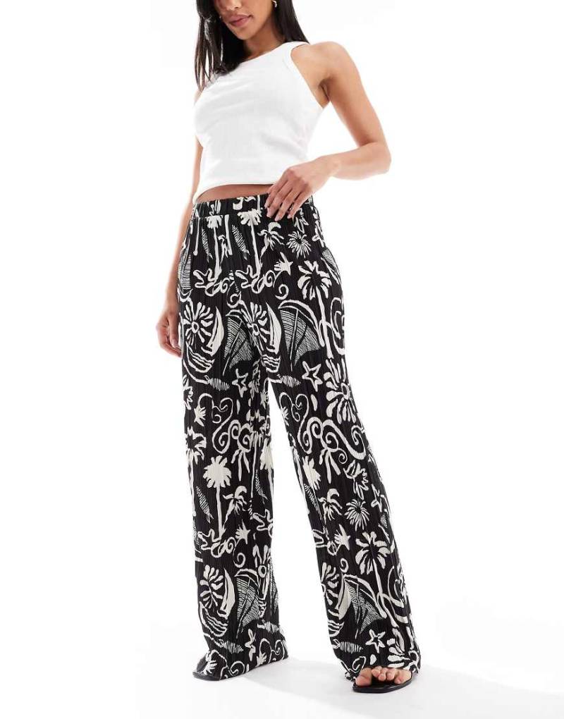 Vero Moda - Plissee-Hose mit hohem Bund, weitem Bein und tropischem Muster-Schwarz Vero Moda - Plissee-Hose mit hohem Bund, weitem Bein und tropischem Muster-Schwarz von Vero Moda