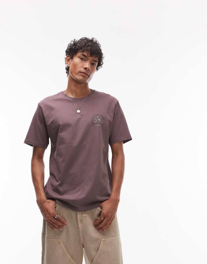 Wrangler - T-Shirt in verwaschenem Braun mit Cowboy-Logo auf der Brust von Wrangler