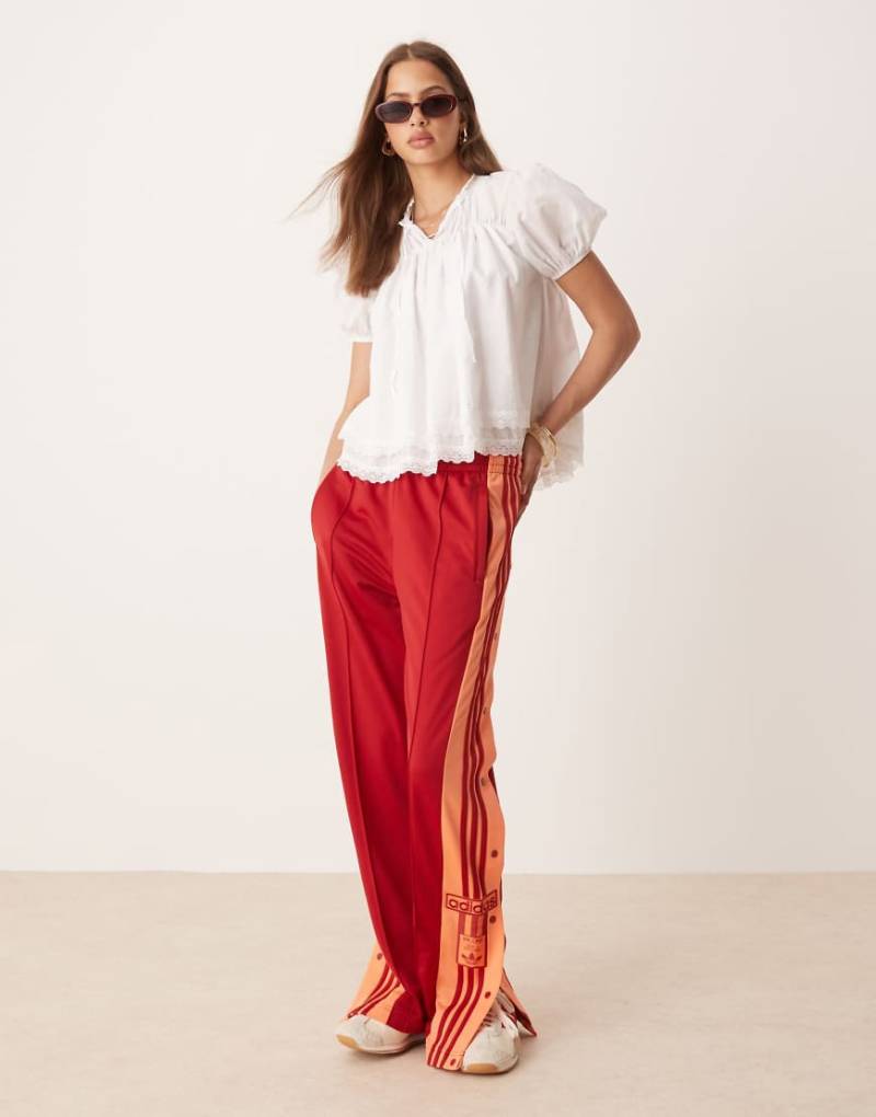 adidas Originals - Adibreak - Trainingshose in Rot und Orange von adidas Originals