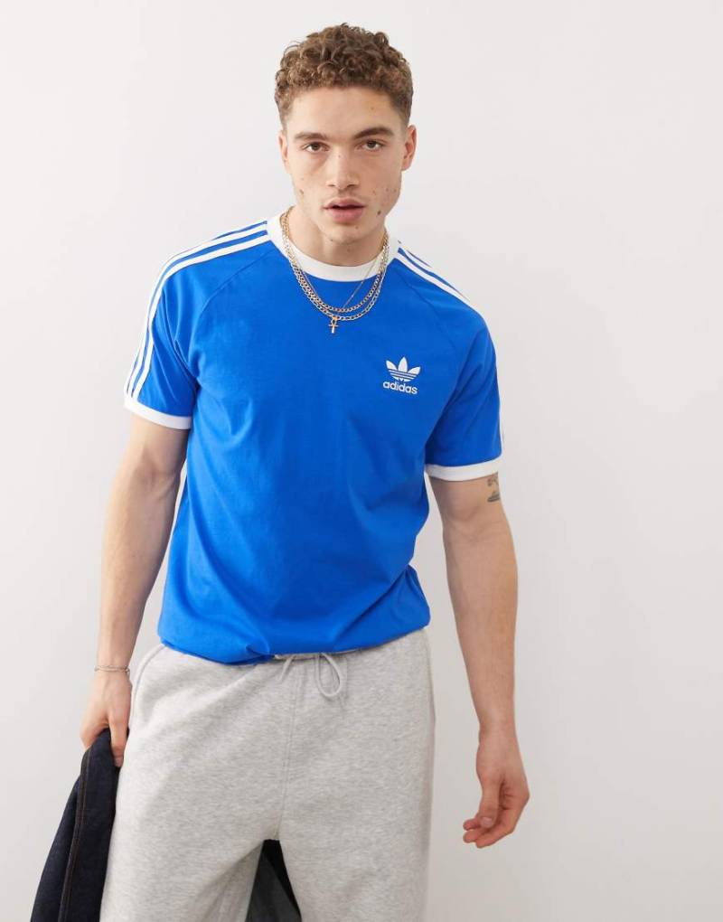 adidas Originals - Adicolor Classics - T-Shirt in Blau mit 3 Streifen adidas Originals - Adicolor Classics - T-Shirt in Blau mit 3 Streifen von adidas Originals