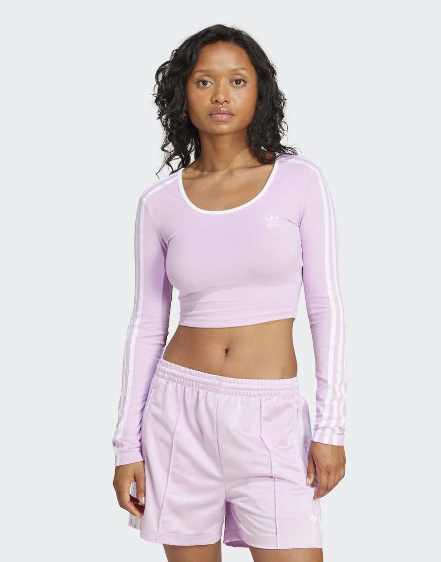 adidas Originals - Adicolor - Langärmliges Cropped-T-Shirt in Light Orchid mit 3-Streifen-Logo-Rosa adidas Originals - Adicolor - Langärmliges Cropped-T-Shirt in Light Orchid mit 3-Streifen-Logo-Rosa von adidas Originals