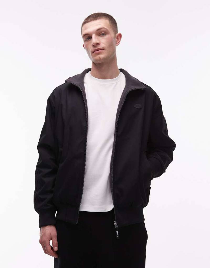 adidas Originals - Firebird - Jacke in verwaschenem Schwarz von adidas Originals