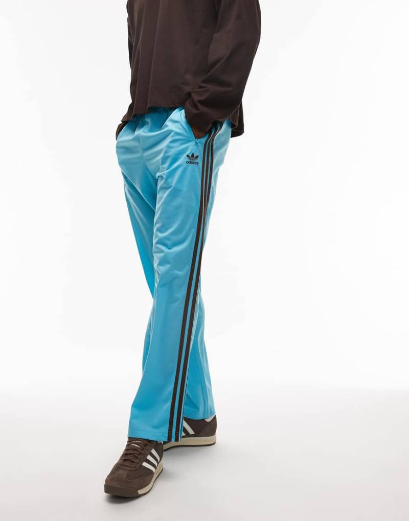 adidas Originals - Firebird - Trainingshose in Blau und Braun von adidas Originals