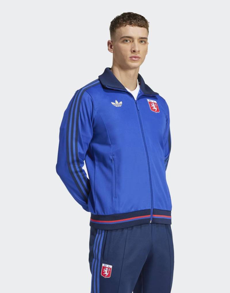 adidas Originals - Olympique Lyonnais - Jubiläums-Trainingsoberteil in Blau adidas Originals - Olympique Lyonnais - Jubiläums-Trainingsoberteil in Blau von adidas Originals