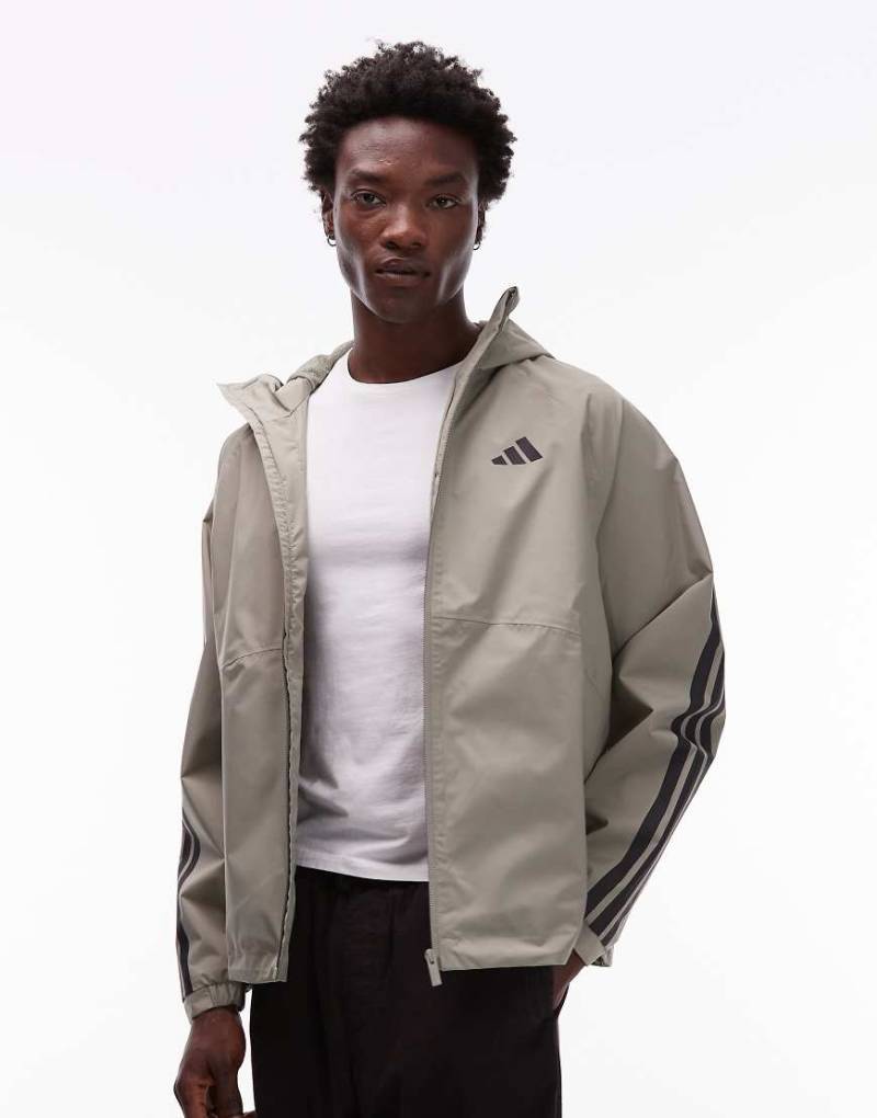 adidas Originals - Regenjacke in Khaki mit den 3 Streifen-Grün von adidas Originals