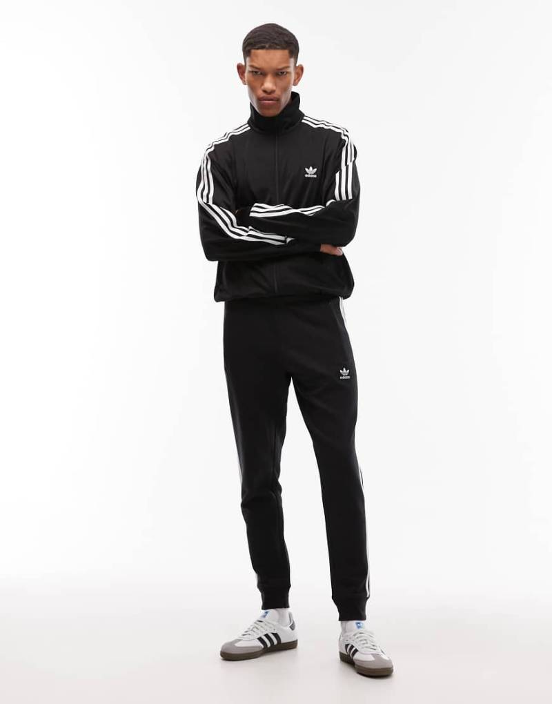 adidas Originals - Schwarze Jogginghose mit drei Streifendesign von adidas Originals