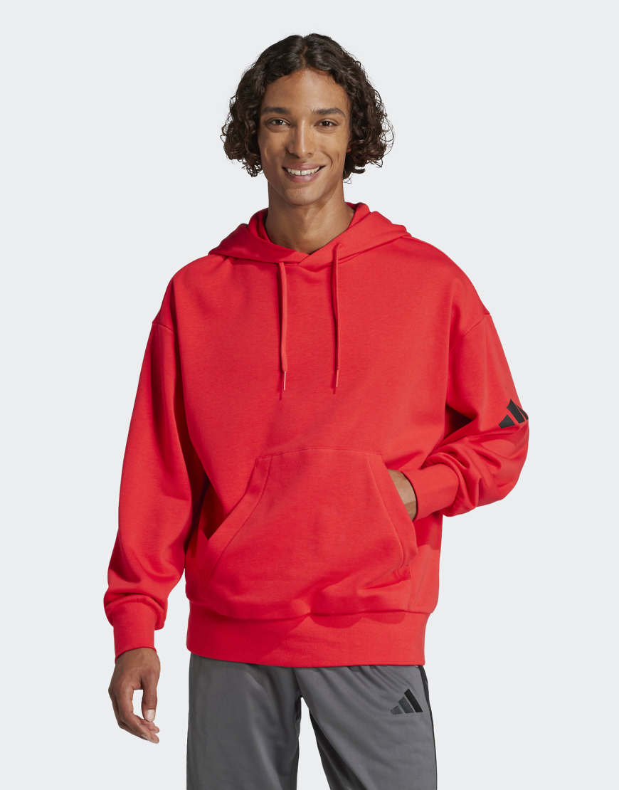 adidas Performance - Essentials - Loose-Fit-Kapuzenpullover aus French Terry in Pure Ruby / Schwarz mit 3-Balken-Logo-Rot von adidas performance