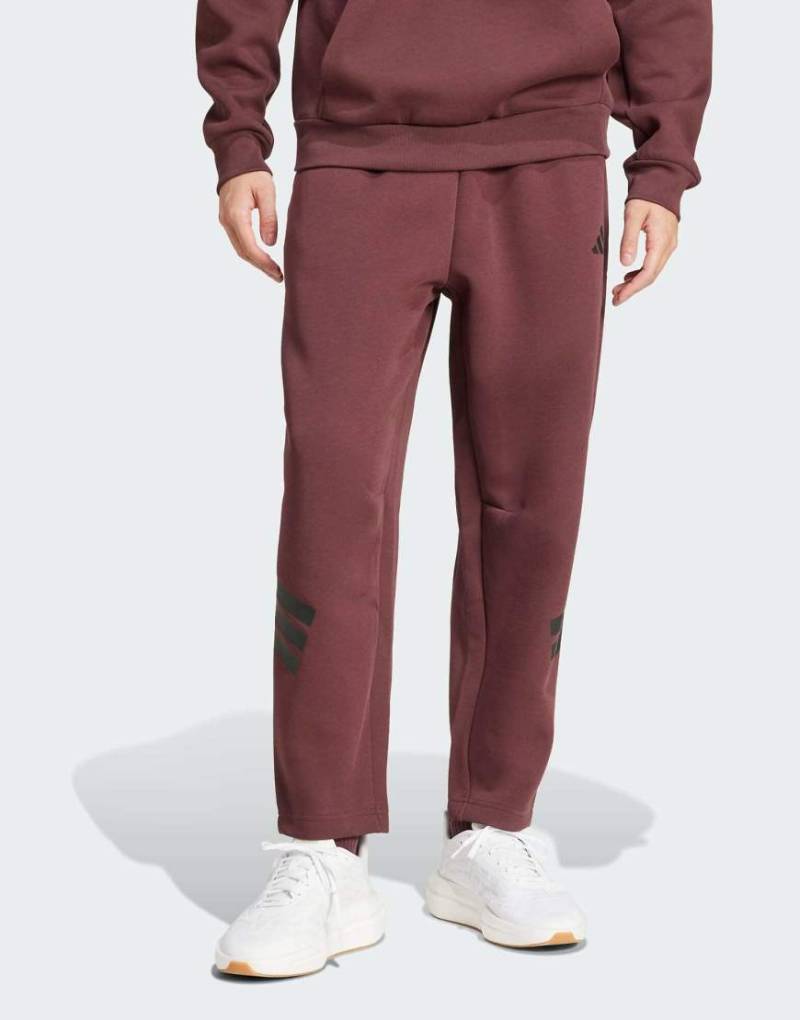 adidas Performance - Future Icons - Hose in Aurora Ruby / Braun mit Tasche und den 3 Streifen-Rot von adidas performance