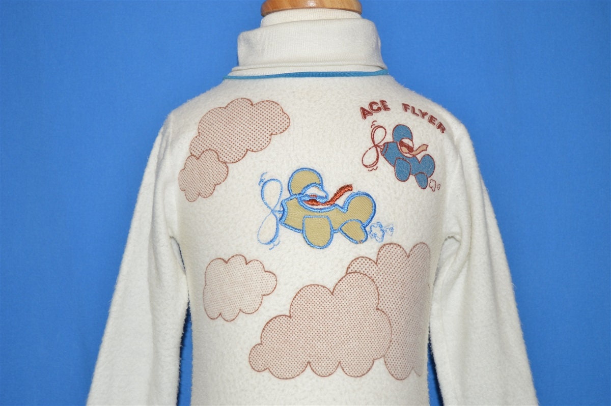 80Er Jahre Ace Flyer Flugzeug Baby Rollkragen Shirt 12-18 Monate 80Er Jahre Ace Flyer Flugzeug Baby Rollkragen Shirt 12-18 Monate von thecaptainsvintage