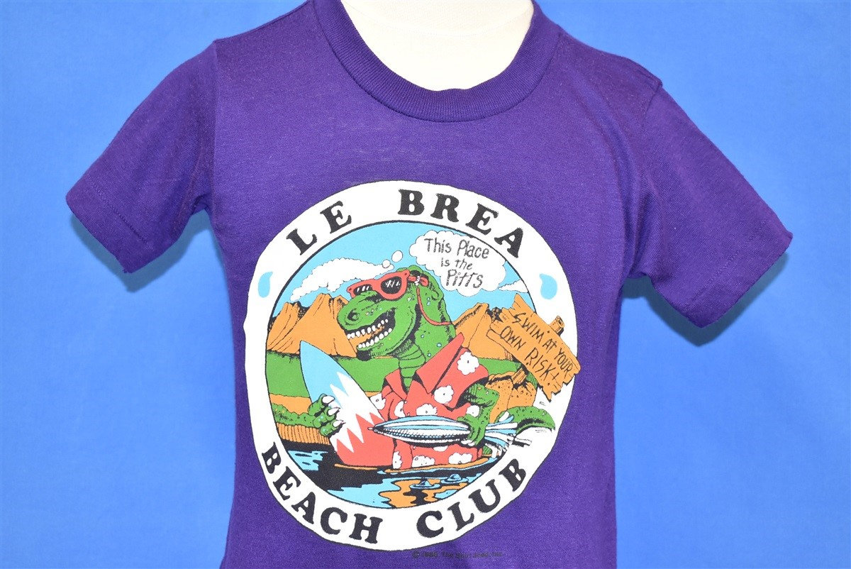 80Er Jahre Le Brea Beach Club Dinosaurier T-Shirt Jugend Medium 80Er Jahre Le Brea Beach Club Dinosaurier T-Shirt Jugend Medium von thecaptainsvintage