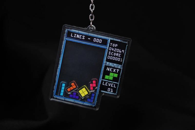 Tetris Shaker Charm - Doppelseitiger Acryl Schlüsselanhänger Mit Tetrominos Im Inneren Tetris Shaker Charm - Doppelseitiger Acryl Schlüsselanhänger Mit Tetrominos Im Inneren von unleashthemerch